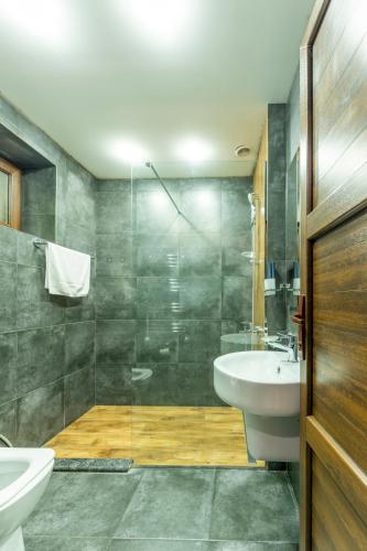 a bathroom with a sink and a toilet and a shower at Maestro Rest House Dilijan in Dilijan