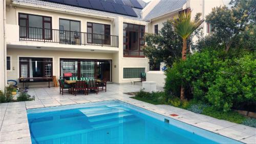 a house with a swimming pool in front of a house at The View in Port Alfred
