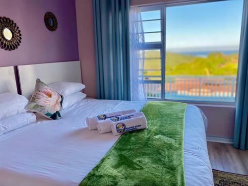 a bedroom with a bed with two towels on it at Clearview Estuary Apartments in East London