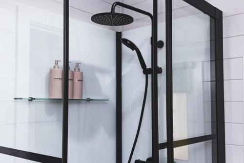a shower with a glass door in a bathroom at AvantGlamp in Marston Green