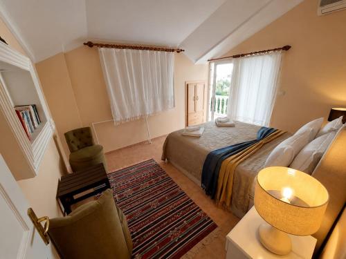a bedroom with a bed and a table and a chair at Dalyan Palace in Dalyan