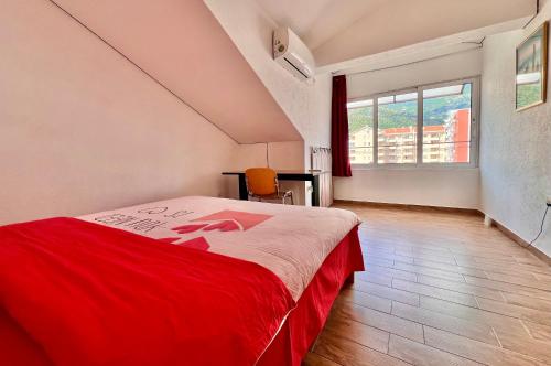 a bedroom with a red bed and a window at Homestay Mark - DOUBLE BED ROOM - shared bathroom in Budva