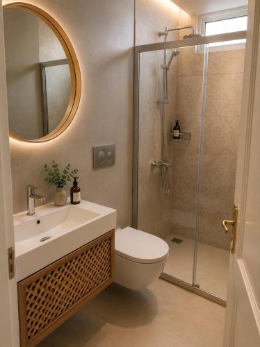 a bathroom with a shower and a toilet and a sink at Dalyan Palace in Dalyan