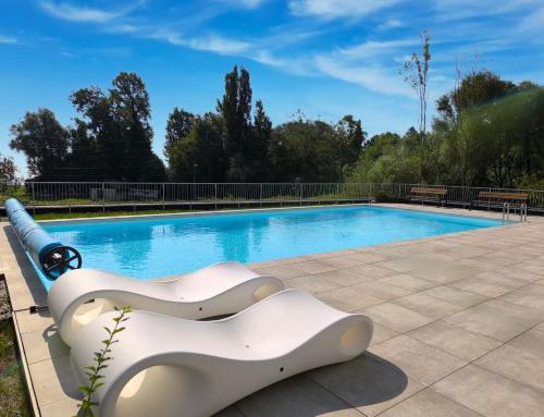 a swimming pool with a white object next to it at Helikon Terasz Apartman in Keszthely