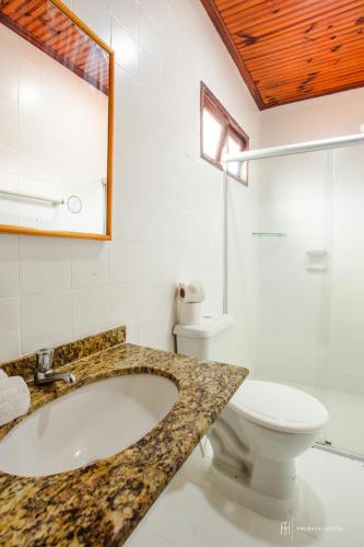 a bathroom with a sink and a toilet at Rede Andrade Galeão in Porto Seguro
