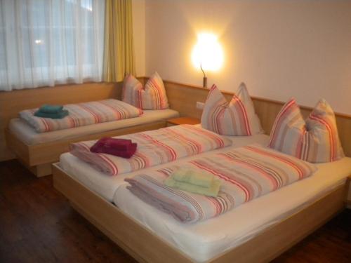 two beds in a hotel room with pillows on them at Appartement Andi in Wagrain