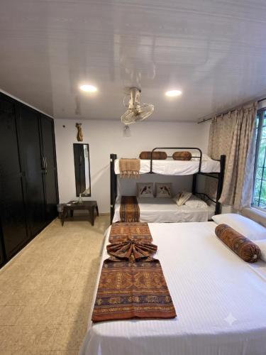 two beds in a room with two bunk beds at HOTEL BOUTIQUE SONNE BALOP Valledupar in Valledupar