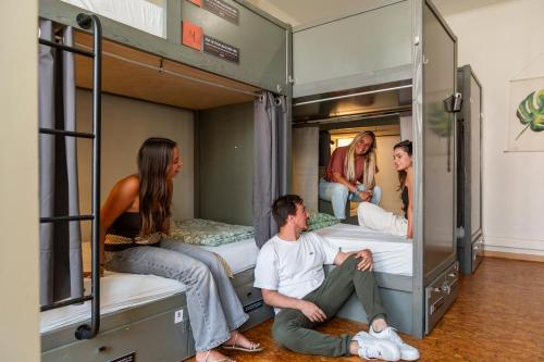 a group of people sitting in a bunk bed at WOT Patio Social in Lisbon