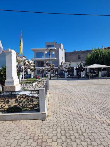 a square with a bench and a flag and a building at Evia Plaza Suites in Amarynthos