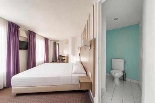 a bedroom with a white bed and a toilet at Get My Hatch Bergère in Paris