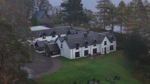 an aerial view of a large white house on a lawn at Taychreggan, Signature Collection by Eight Continents in Oban