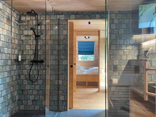 a bathroom with a shower and a glass door at Wellness Chalet unterm Trifels in Annweiler am Trifels