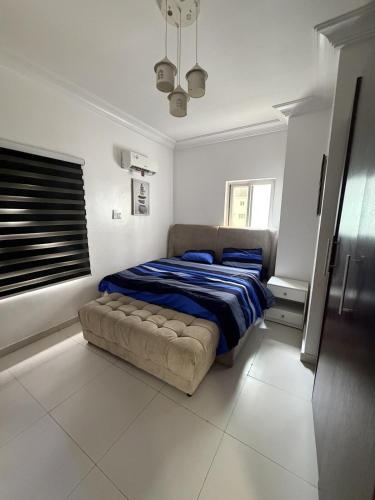 a bedroom with a bed and a couch in it at The Luxe Haven in Lekki Phase 1