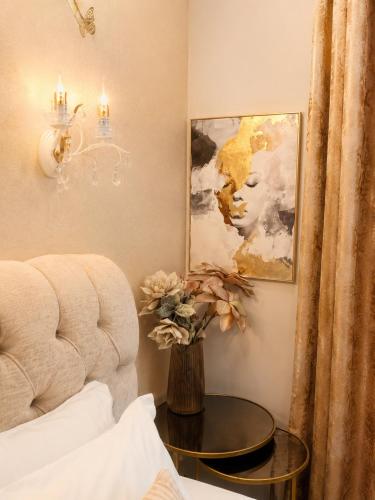 a living room with a chair and a table at GOLDENSPACE by Evagelias Homes Volos in Volos