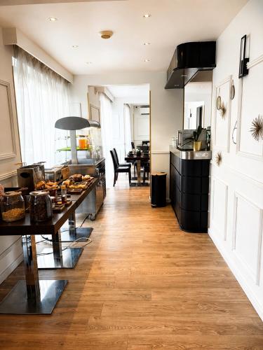 a kitchen with a table with food on it at Hôtel Gallia Cannes in Cannes
