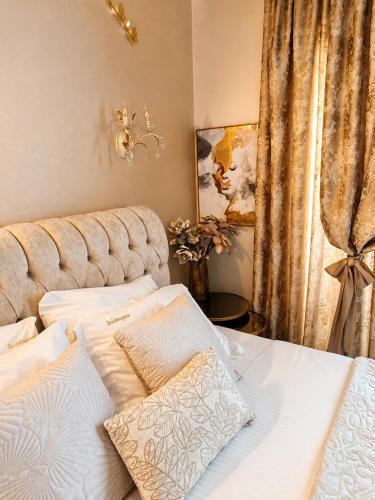 a bedroom with a bed with two white pillows at GOLDENSPACE by Evagelias Homes Volos in Volos