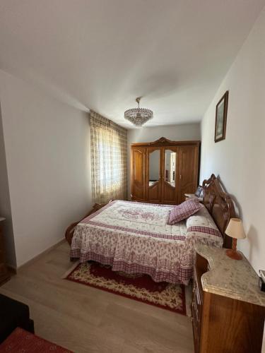 a bedroom with a bed and a dresser and a table at Casa da Xueza in Vales
