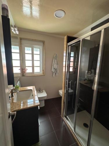 a bathroom with a sink and a shower at Casa da Xueza in Vales