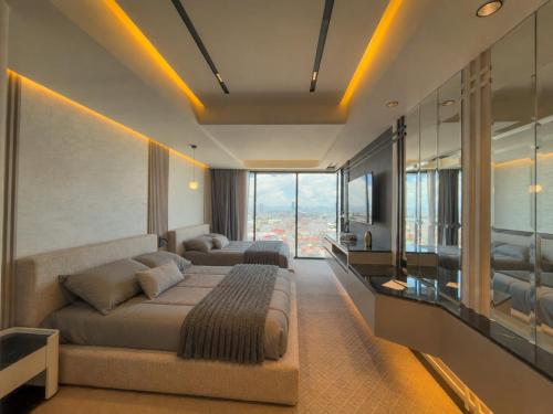 a bedroom with two beds and a large window at PISO 13 SM Living Street Mall in Puebla