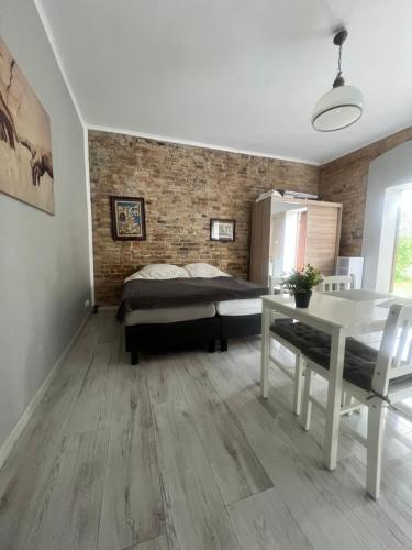 a bedroom with a bed and a table in it at Louis Apartaments Kostrzyn in Kostrzyn nad Odrą