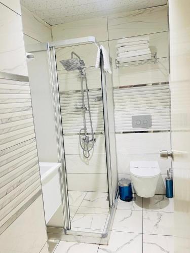 a bathroom with a shower and a toilet at Grand Gülizar Otel in Urfa