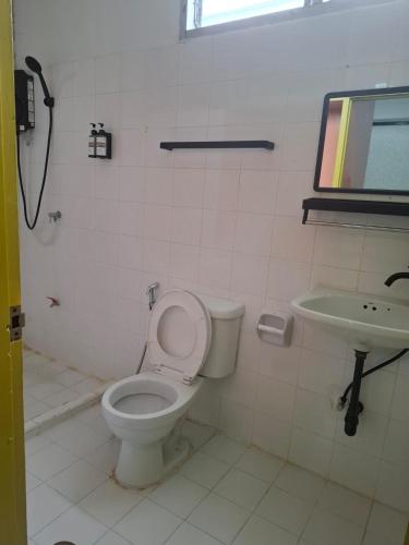 a bathroom with a toilet and a sink at Happy 2 Pratunam Hotel in Bangkok