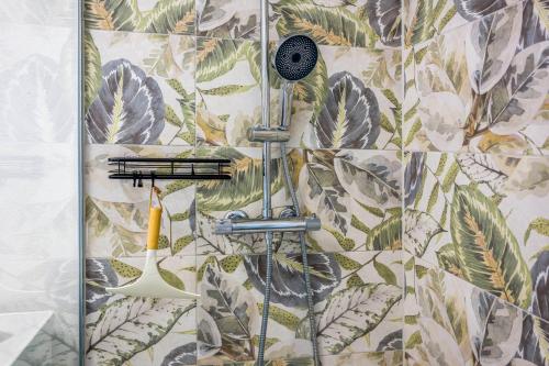 a shower in a bathroom with a tile wall at Romy in Reischach