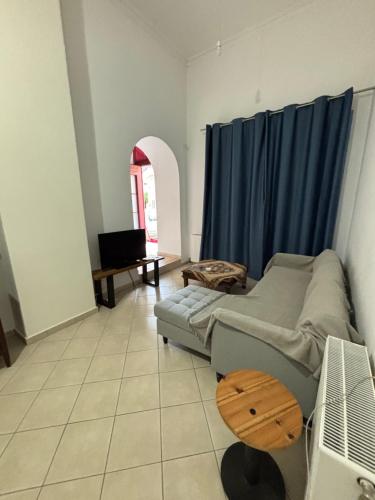 a living room with a couch and a table at The Old Winery in Aliveri