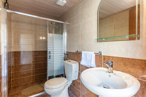 a bathroom with a toilet and a sink and a shower at Echo 1-BR Apartment In Ejdabra Batroun 