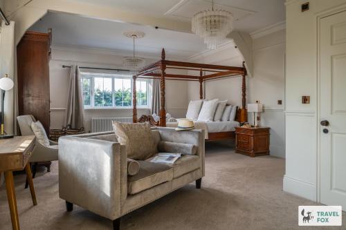 a living room with a couch and a bed at The Plas - Rhosneigr Manor House in Rhosneigr