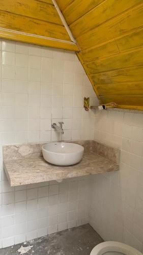 a bathroom with a sink and a toilet at Casa da Raposa in Iguaíba