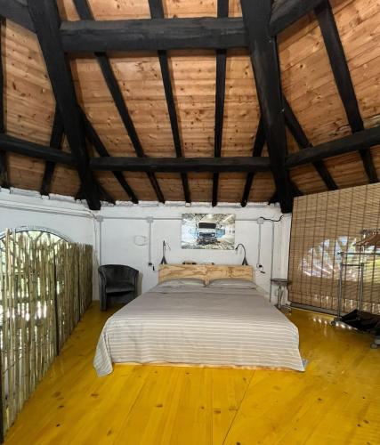 a bedroom with a bed in a room with wooden floors at Il Casale di Bubu in Modena