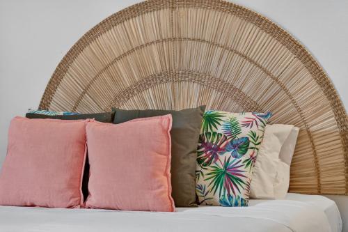 a bunch of pillows sitting on top of a bed at Casa da Abegoaria in Caniço