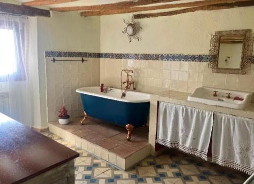 a bathroom with a large tub and a sink at Urbasako Argizar Etxea in Larraona