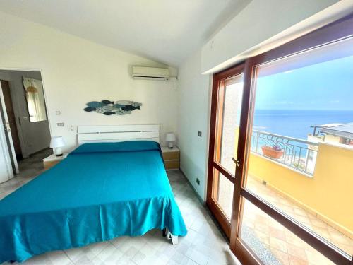 a bedroom with a bed and a view of the ocean at Casa Cucchiara in Bagnara Calabra
