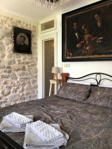 a bedroom with a bed and a painting on the wall at Villa Old Mariner in Kotor