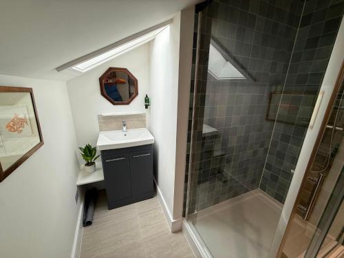 a bathroom with a sink and a shower at The Music Rooms in Bewdley
