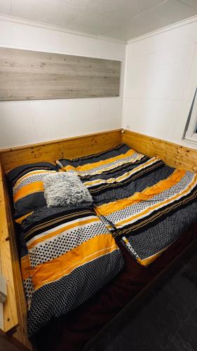 a wooden bunk bed with orange and black blankets at Chata u Zajpta in Ústí nad Labem