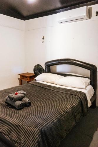 a bedroom with a bed with a blanket at Alto Saudade - Atins in Barreirinhas