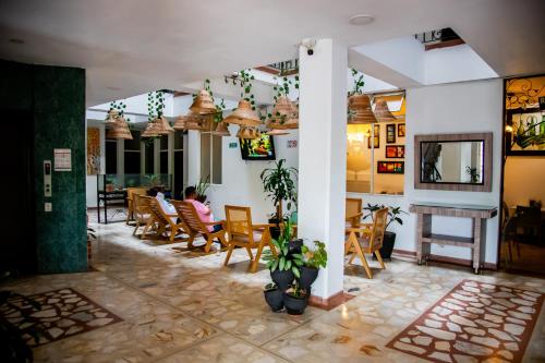 a restaurant with people sitting in chairs in a room at Hotel Macedonia Plaza Itagui in Medellín