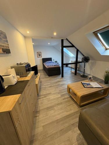 a kitchen and living room with a bed in a room at Gästehaus-City in Helmstedt