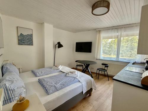 a bedroom with a bed and a desk and a table at Payerbach Apartments in Payerbach