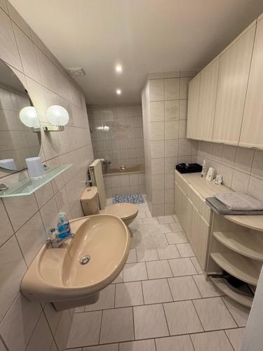a bathroom with a sink and a toilet at Gästehaus-City in Helmstedt