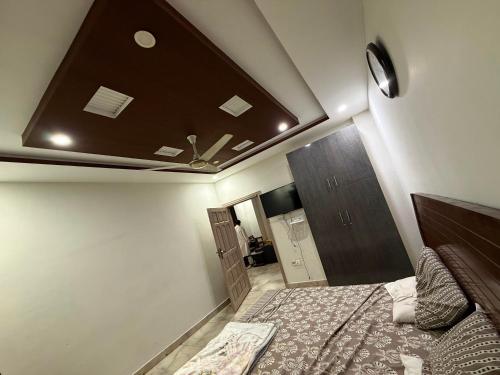a bedroom with a ceiling with a bed in it at Khushal Residence in Peshawar