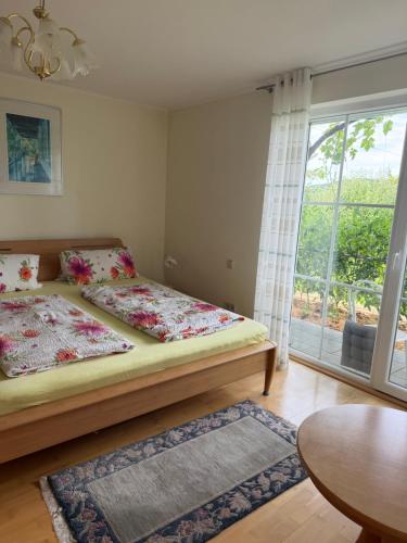 a bedroom with two beds and a large window at Idyllisches Wohnen Weinberg in Bad Kissingen