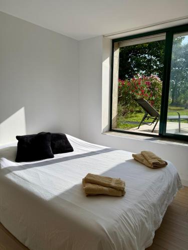 a bedroom with a large white bed with towels on it at La Prairie 65 in Lafitole