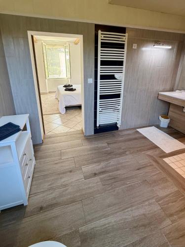 a kitchen with wooden floors and a table in a room at La Prairie 65 in Lafitole
