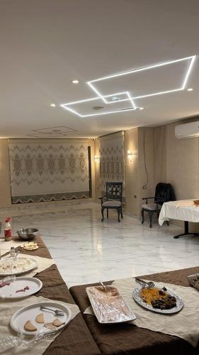 a room with a table with plates of food on it at Antalya Hotel Am in Amman