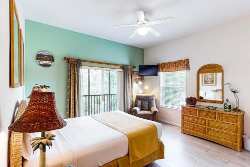a bedroom with a bed and a large window at Exclusive 3BR villa: pools near Disney magic in Kissimmee