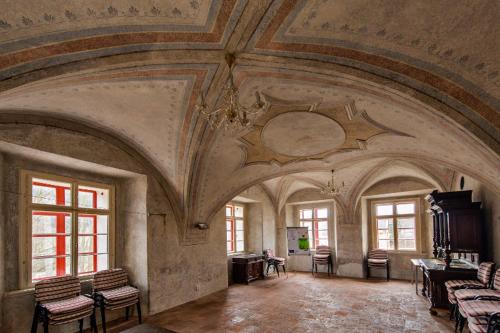 a large room with an ornate ceiling and windows at Ekocentrum DOTEK in Horní Maršov